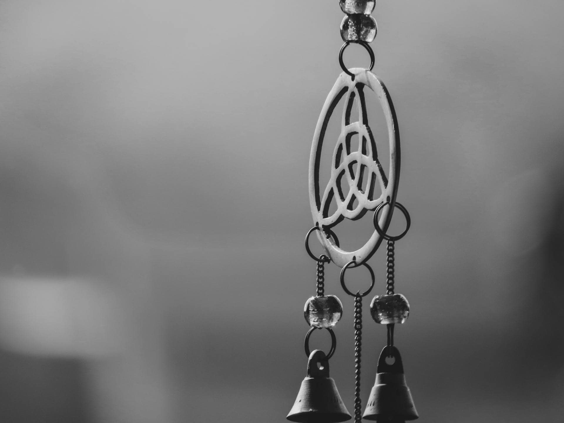 Silver dreamcatcher with bells in black and white style.