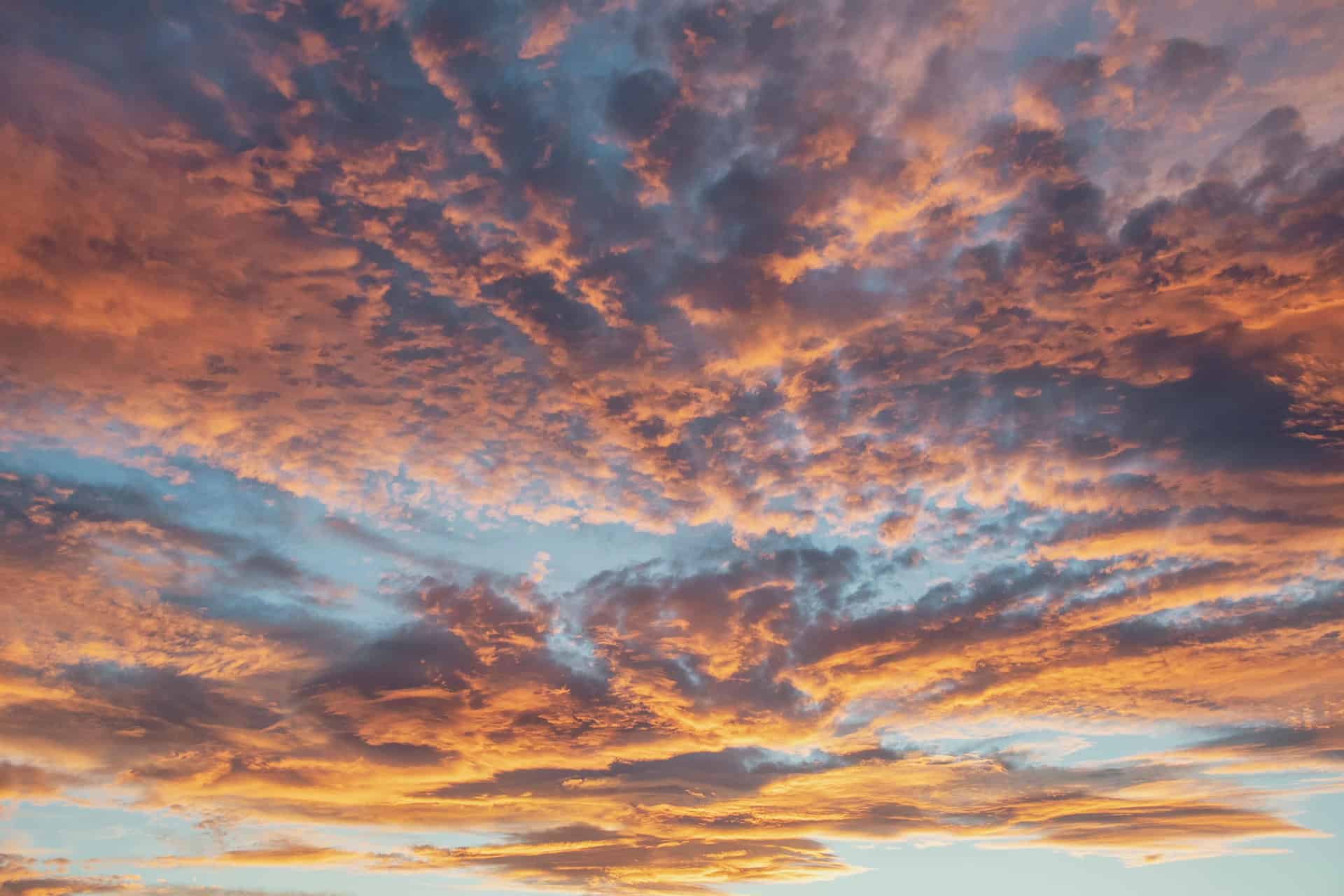 Vivid orange and pink clouds at sunset over the Irish sky, showcasing natural beauty and evening tranquility.