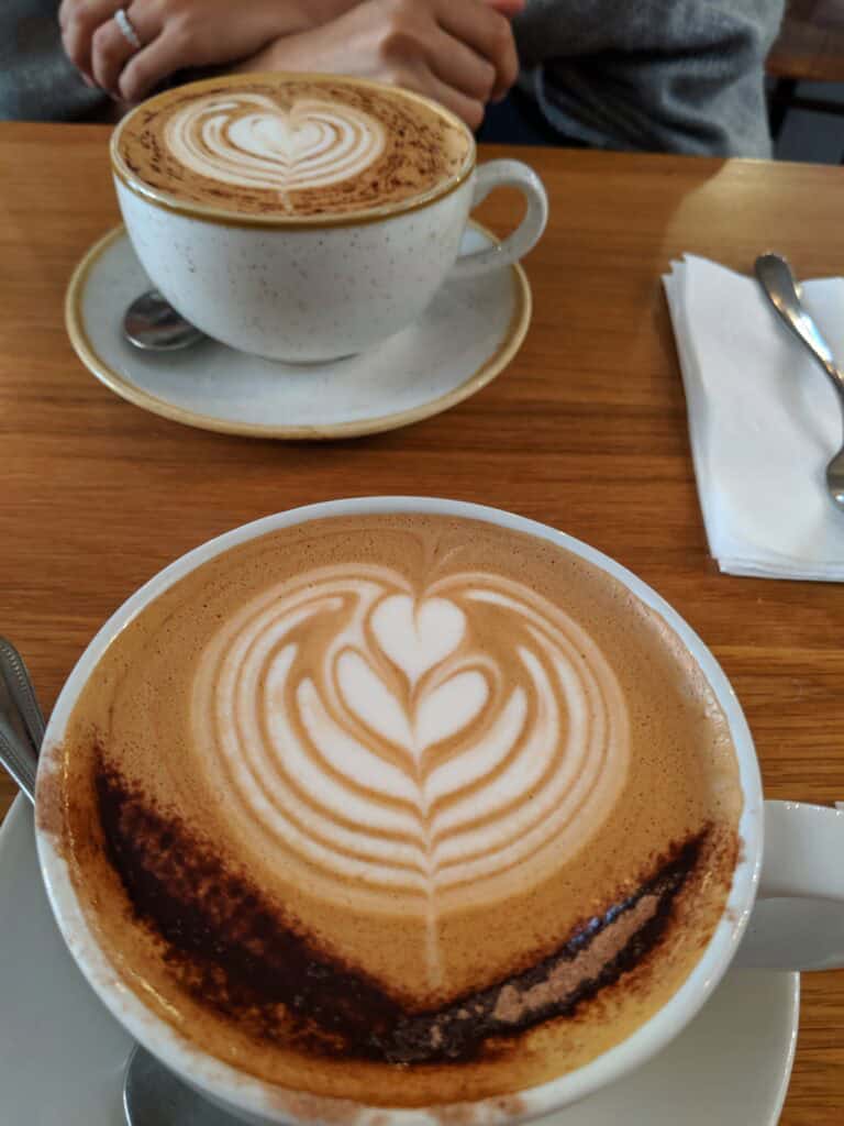 Two cups of Irish coffee with latte art in Dublin cafe.