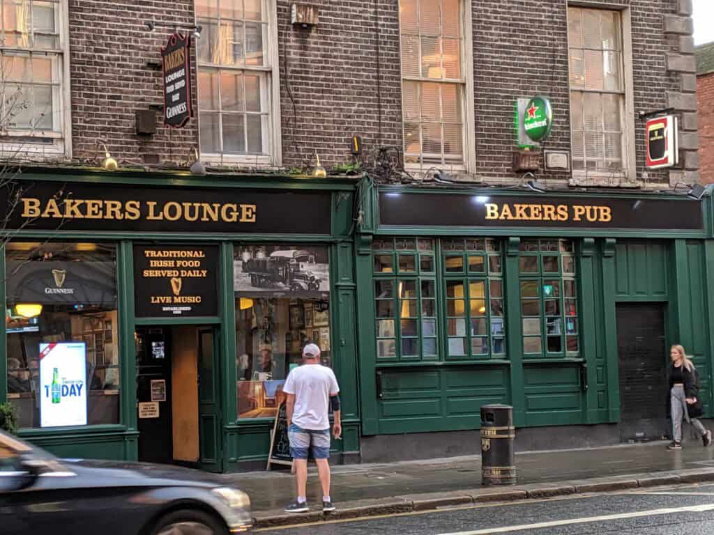 Bakers Lounge and Pub exterior in Ireland with people outside.