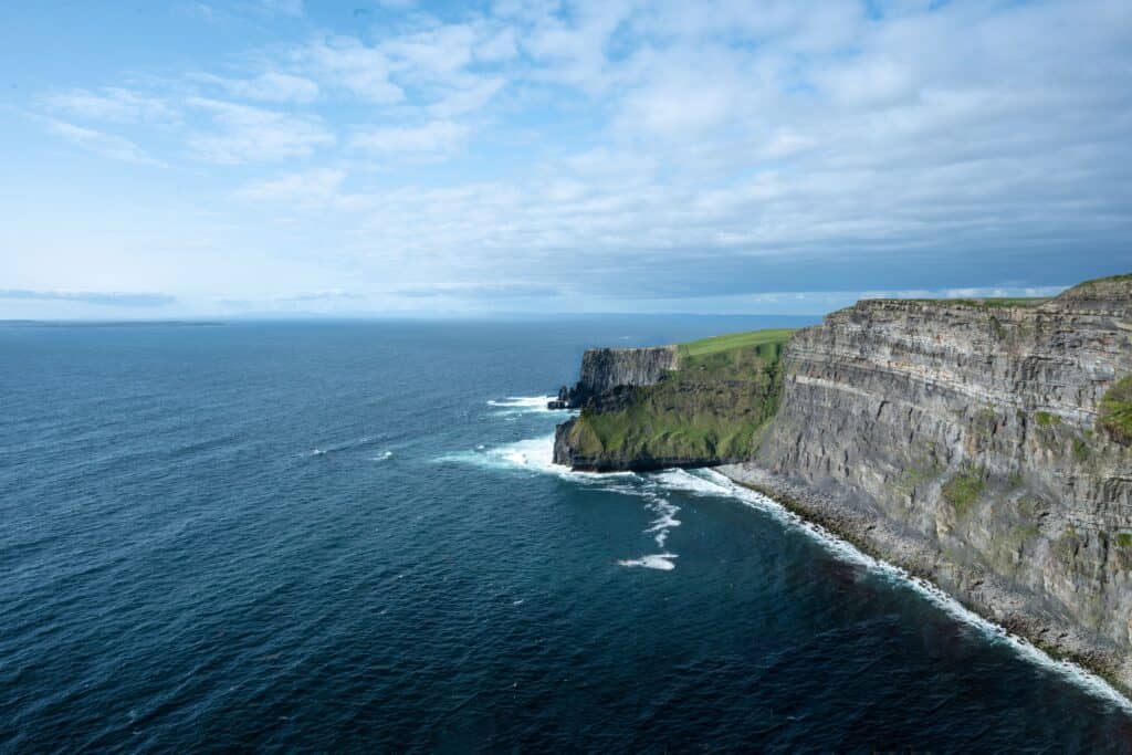 Stunning aerial capture of the Cliffs of Moher and the Atlantic Ocean in Ireland.