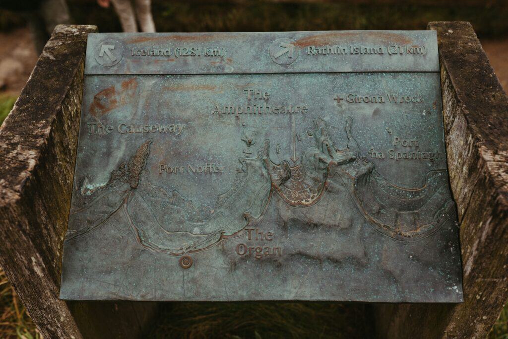 Detailed metal plaque depicting a map of Giant's Causeway in Northern Ireland.