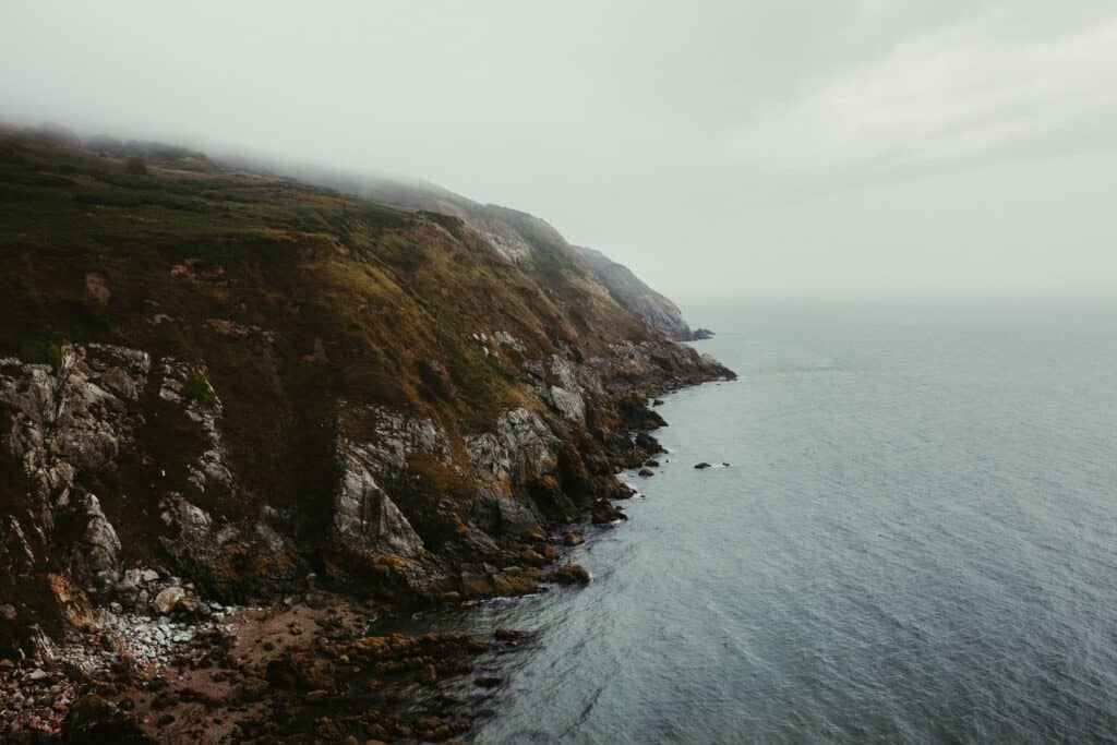 Explore the rocky cliffs of Howth with a misty seaside view in Dublin, Ireland.