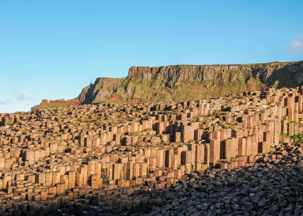 Stunning view of Giant's Causeway with hexagonal basalt columns and cliffs.