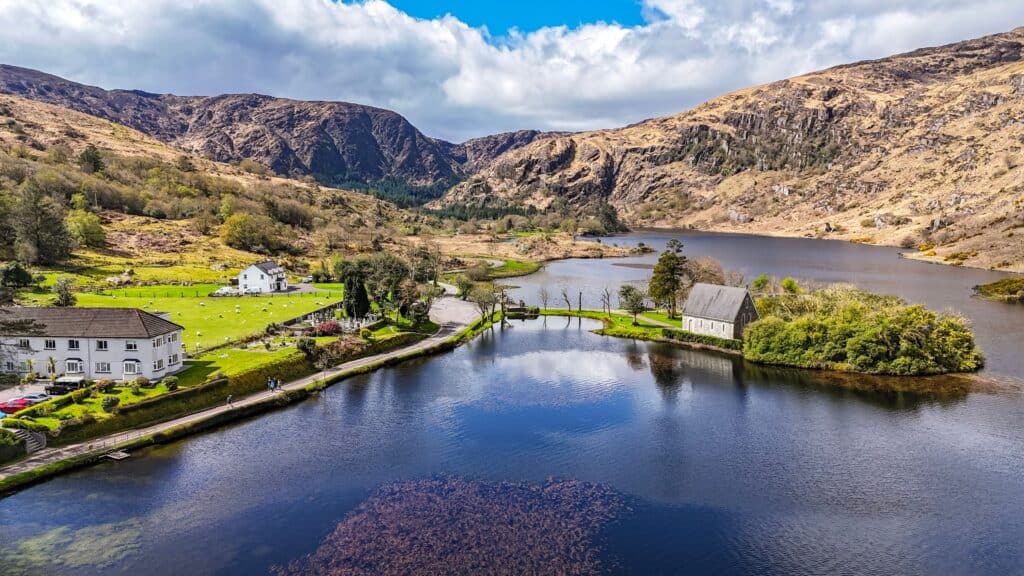 Irish lake with mountains and houses in County Kerry.