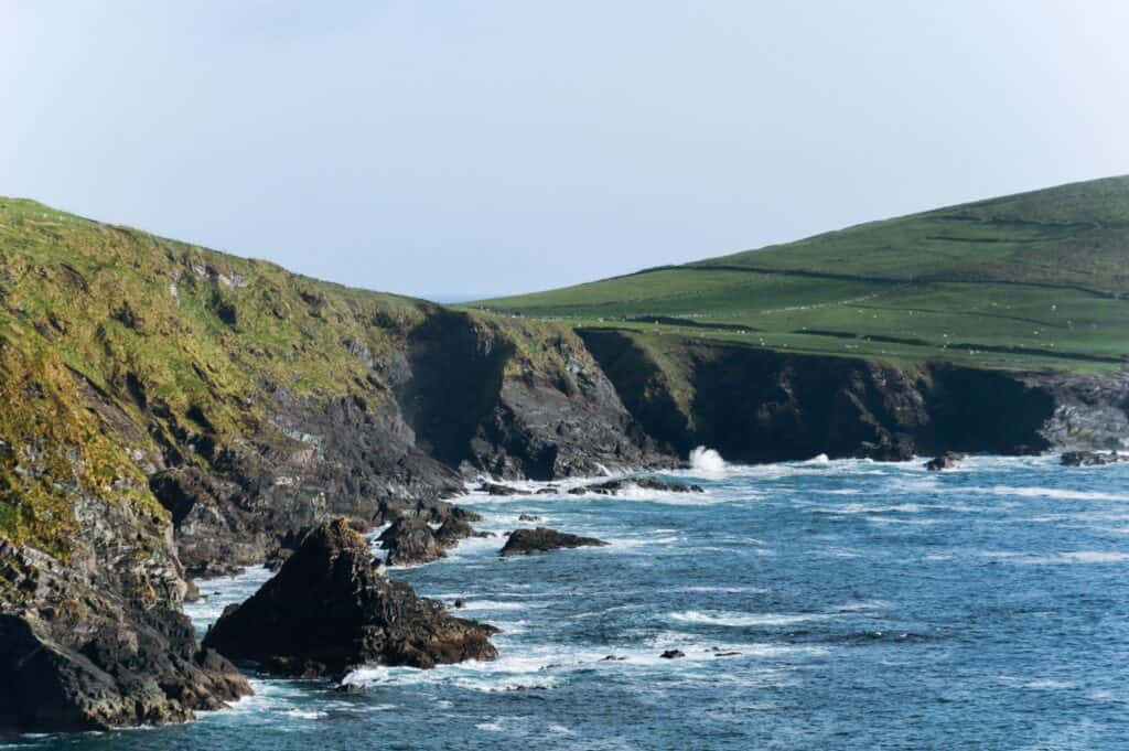 Stunning view of rugged cliffs and ocean waves along the Kerry coastline in Ireland.