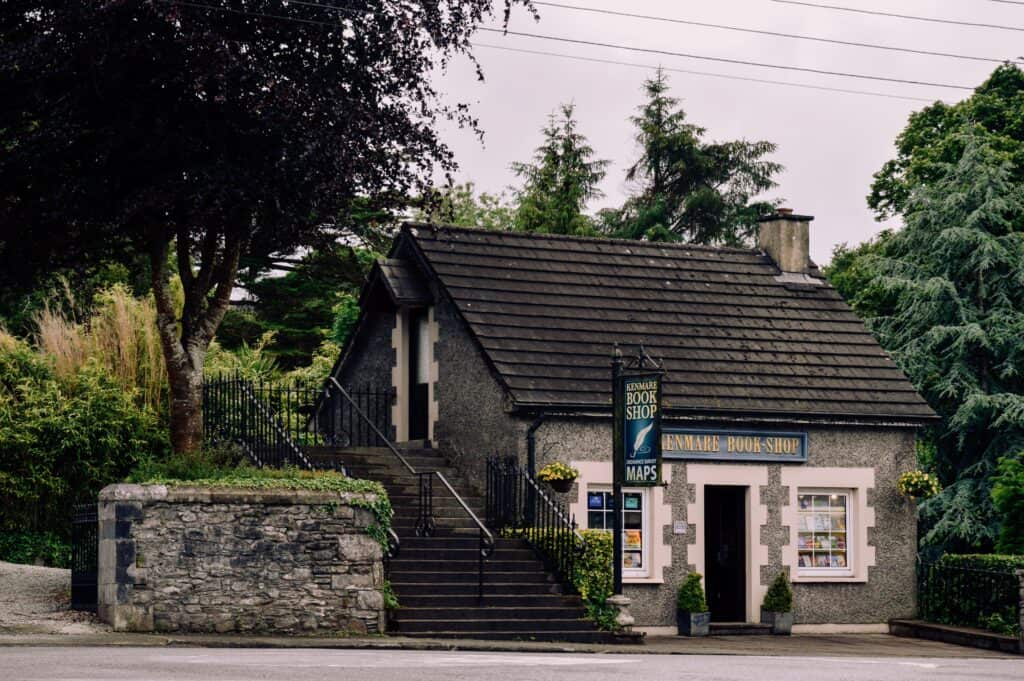 Quaint Kenmare bookshop with lush greenery, offering a serene literary retreat in Ireland.