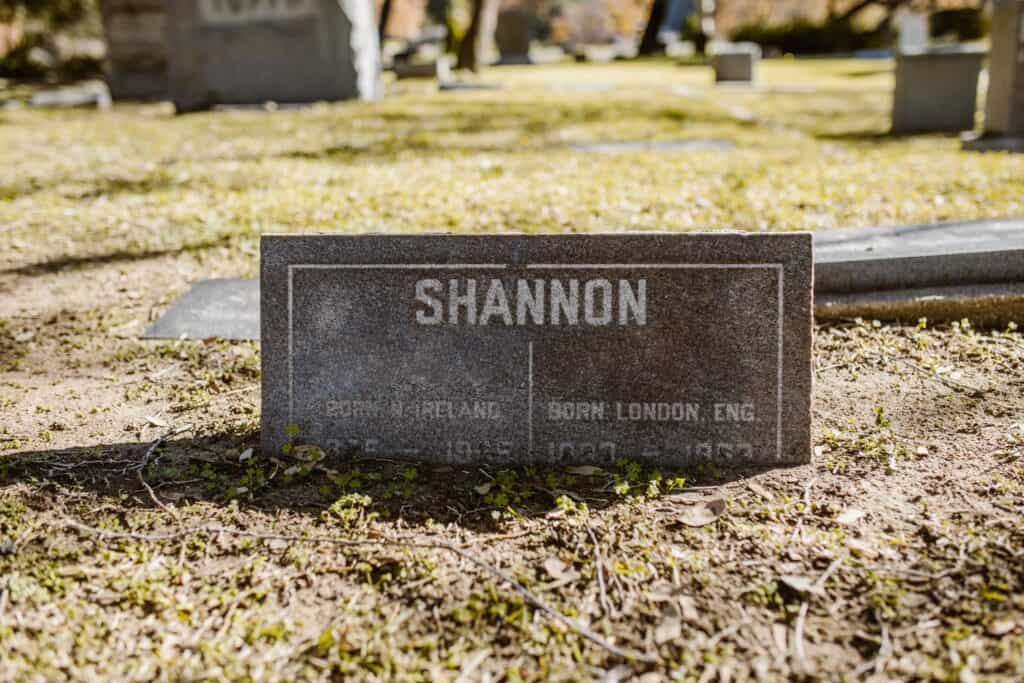 Gravestone marked 'Shannon' in sunlit cemetery grounds, capturing historical significance.