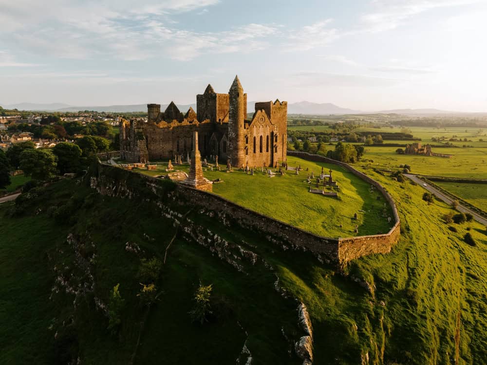 Blarney Castle in Ireland with surrounding landscape and sky.