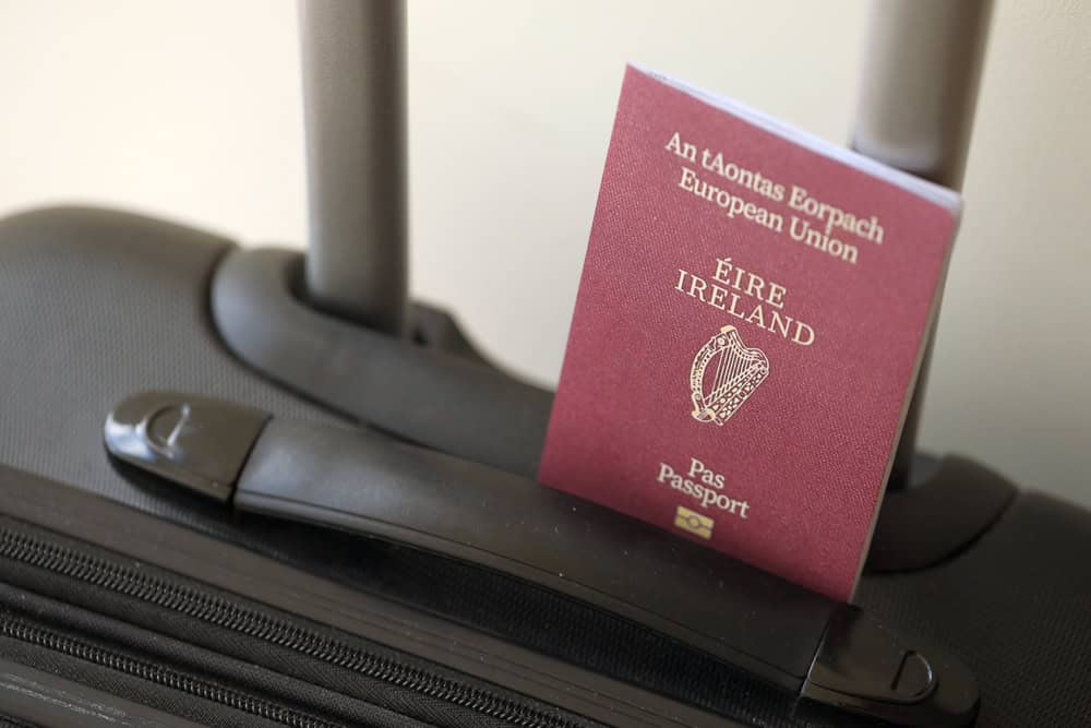 Irish passport in suitcase handle, Ireland travel.