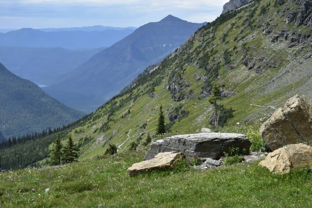 View of Glacier National Park mountains and green valley.