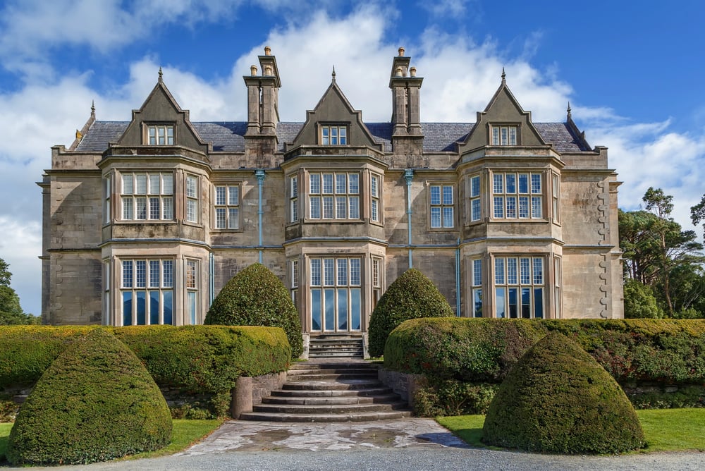 muckross house from the front angle with bushes