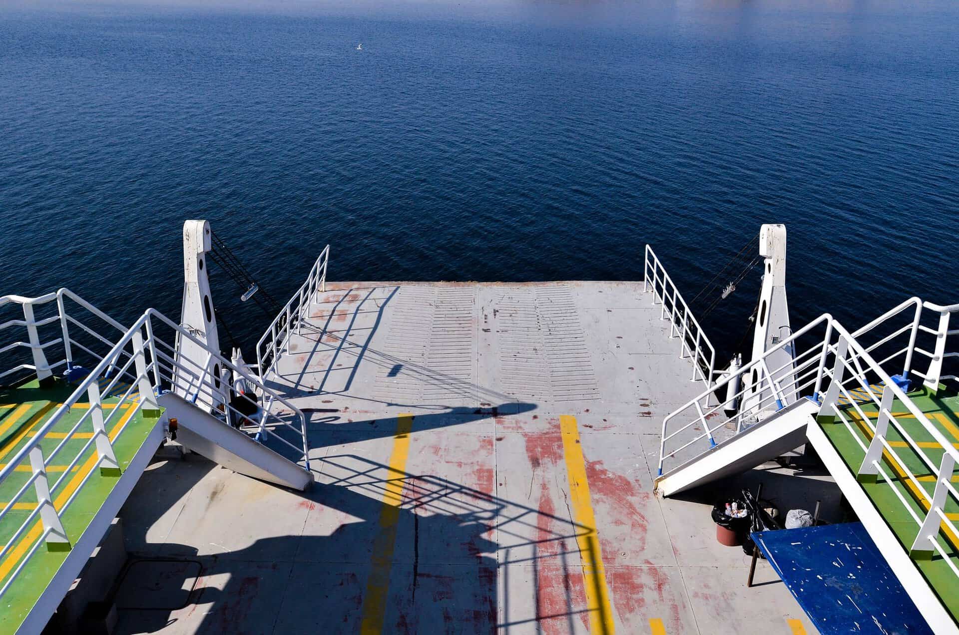 Empty vehicle deck and loading ramp on a ferry overlooking the sea