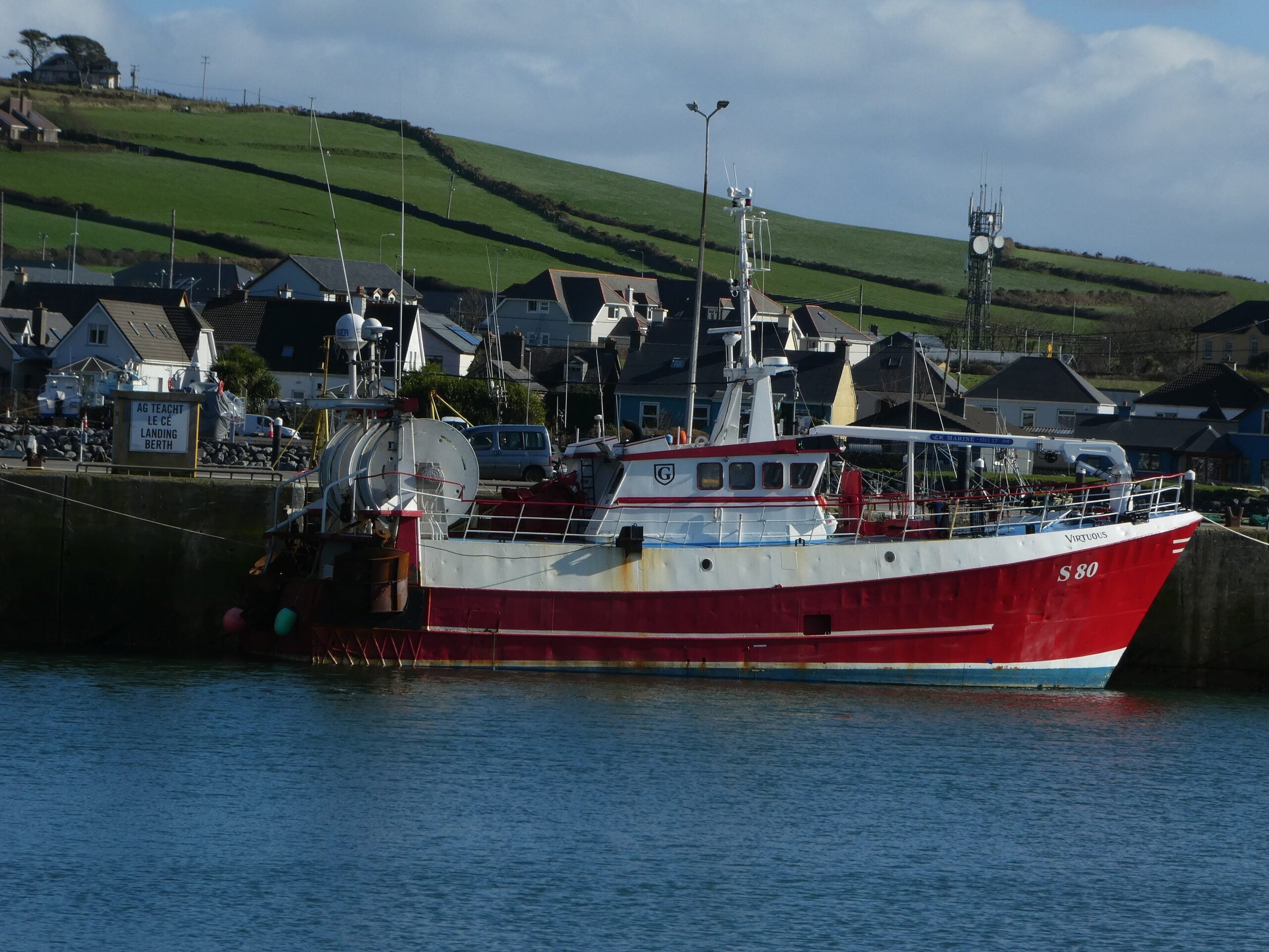 Boat-1130127, Dingle, Co. Kerry, Ireland: Fishing trawler at berth on the pier of Dingle Harbour, with bilingual Irish-English berthing quay sign.