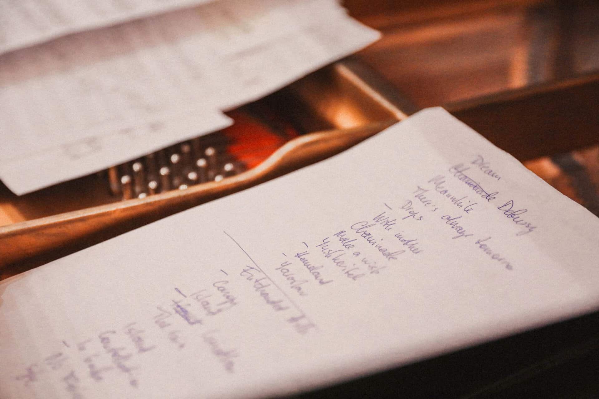 Close-up of a handwritten checklist on paper in warm light. Ideal for planning and organization themes.