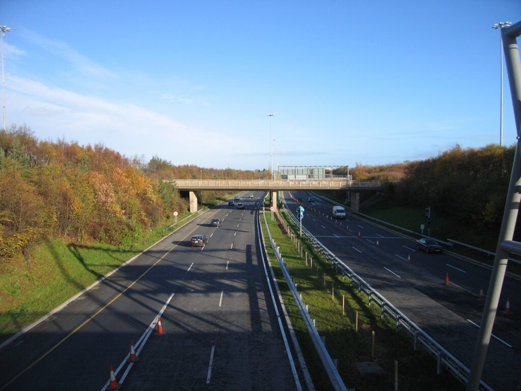 M50 Santry: M50 northbound at Santry; cars from Whitehall on the N1 in left lane, trucks from tunnel (M50) emerging in middle lane. (This is Junction 1 of the M50). Trucks following M50 must get into