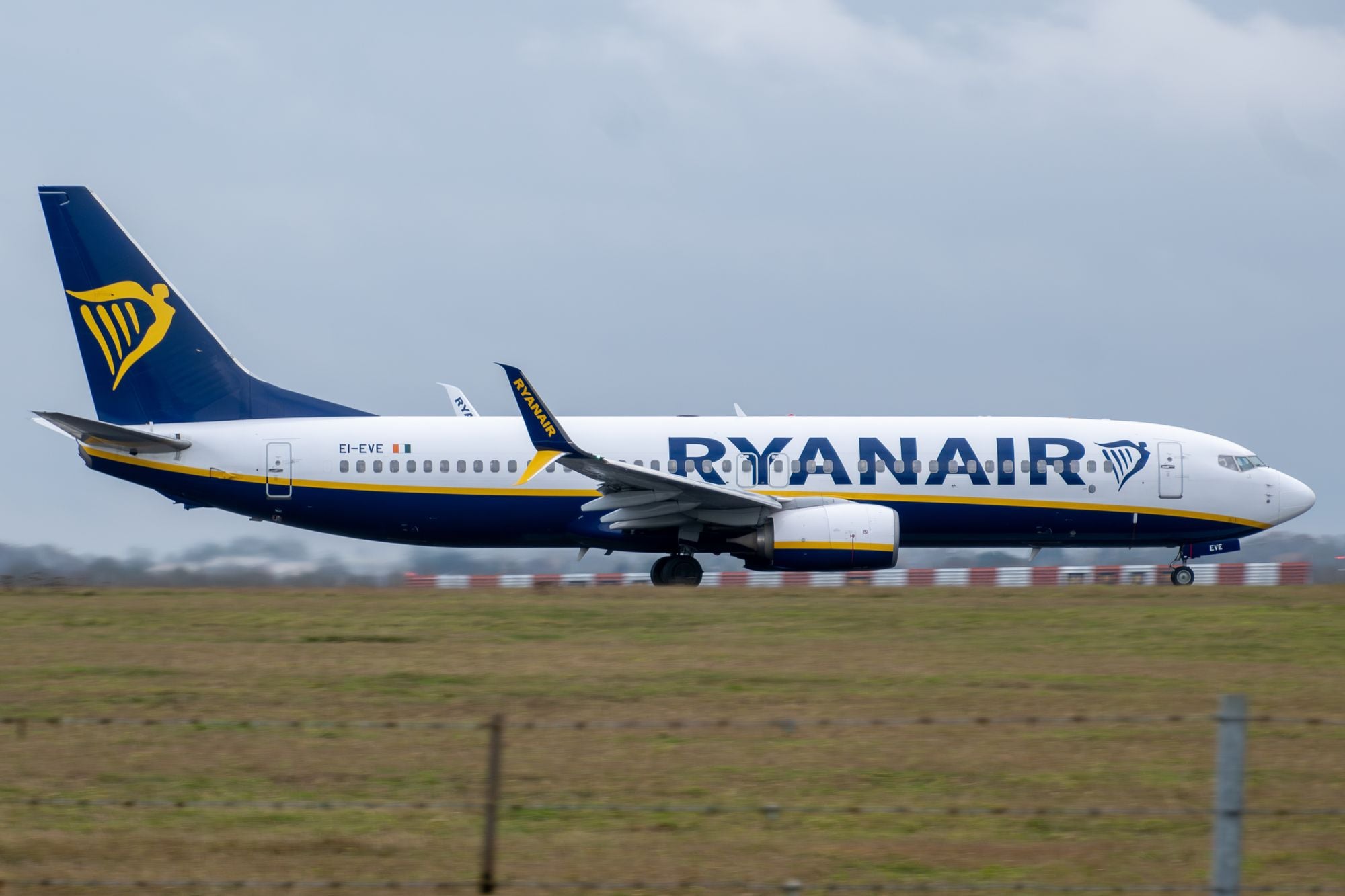 Ryanair Boeing 737 aircraft taxiing on runway at airport during daytime.