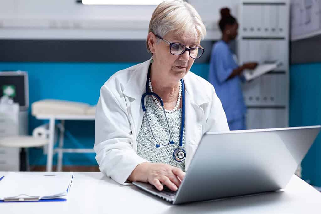 medical professional using a laptop to protect data information
