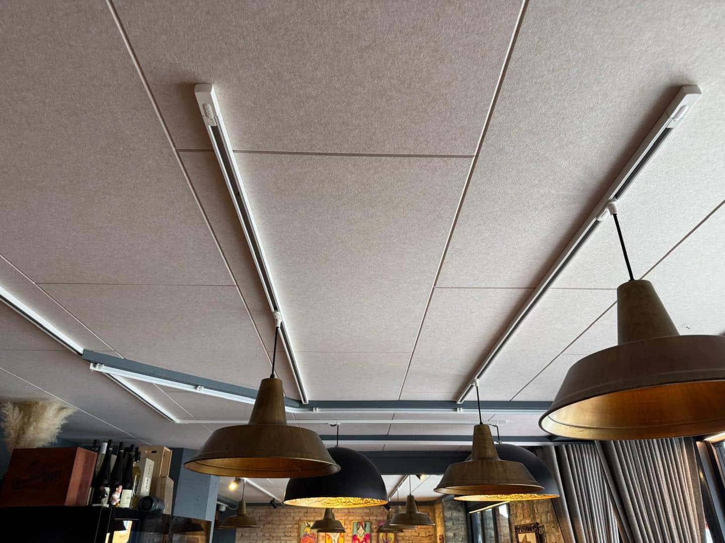 Loftsløsning til restaurant i Aarhus med moderne træpaneler og belysning.