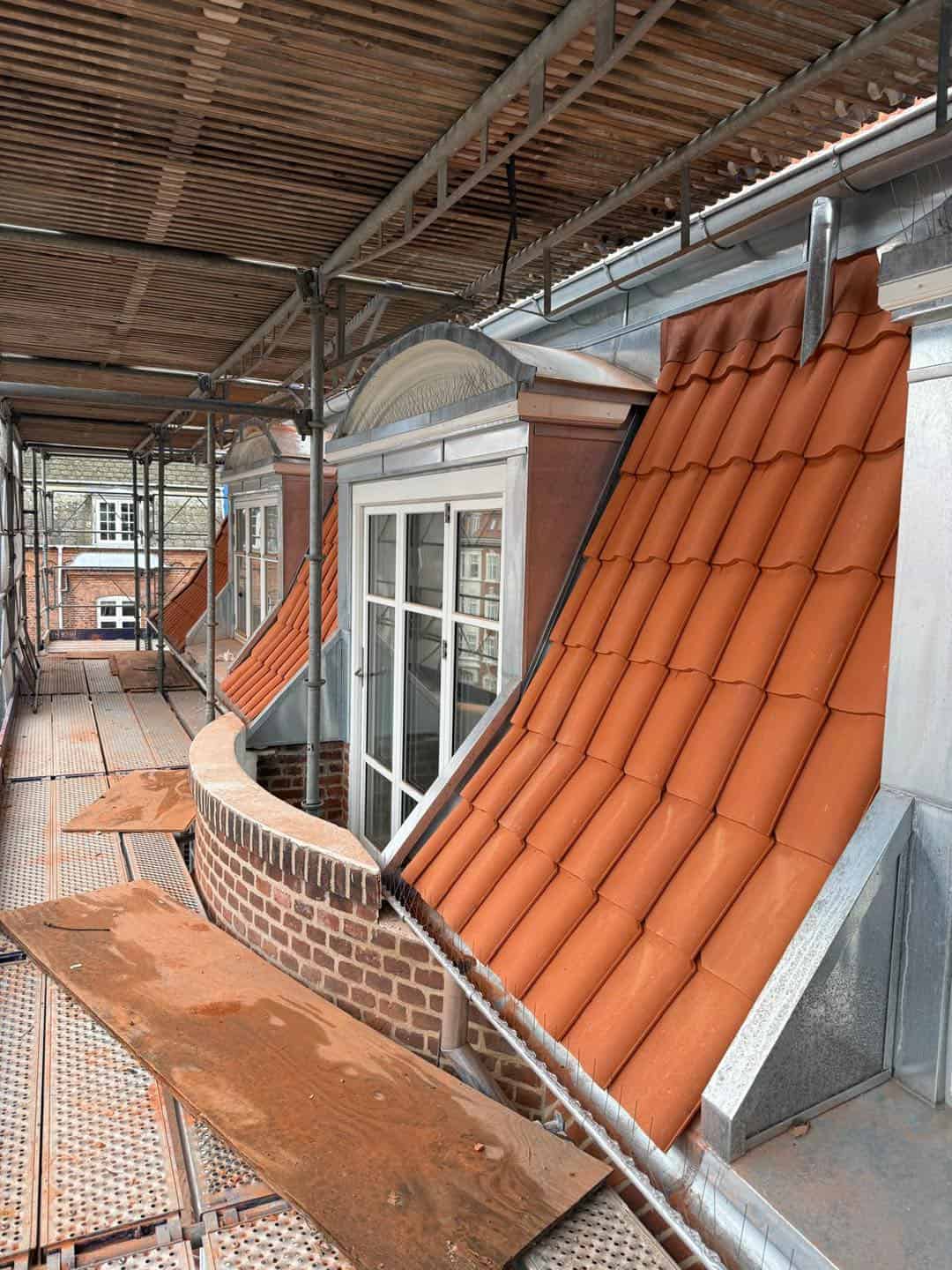 Nyt tag med terrakottafliser på ældre ejendom under renovering.