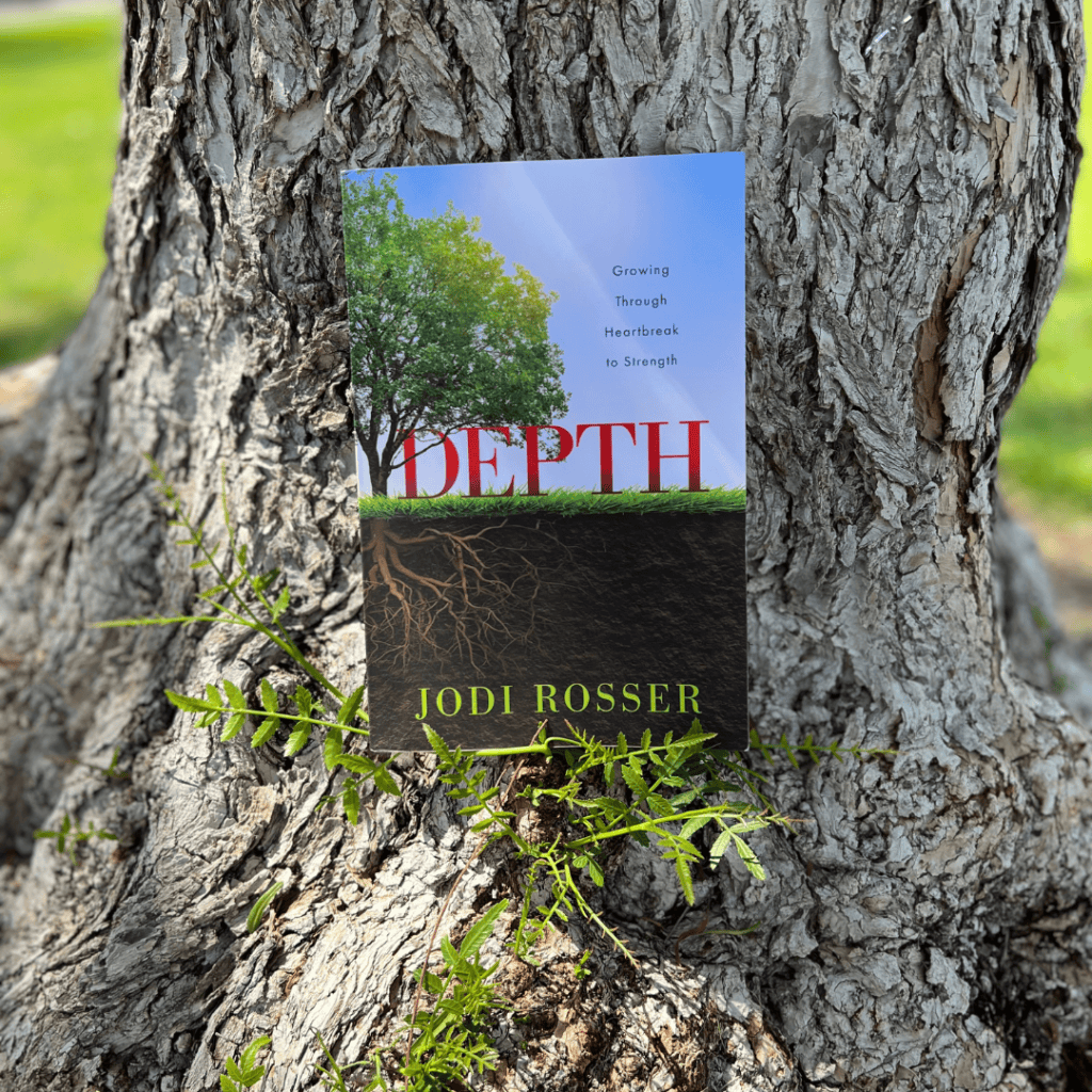 Depth book resting against a tree