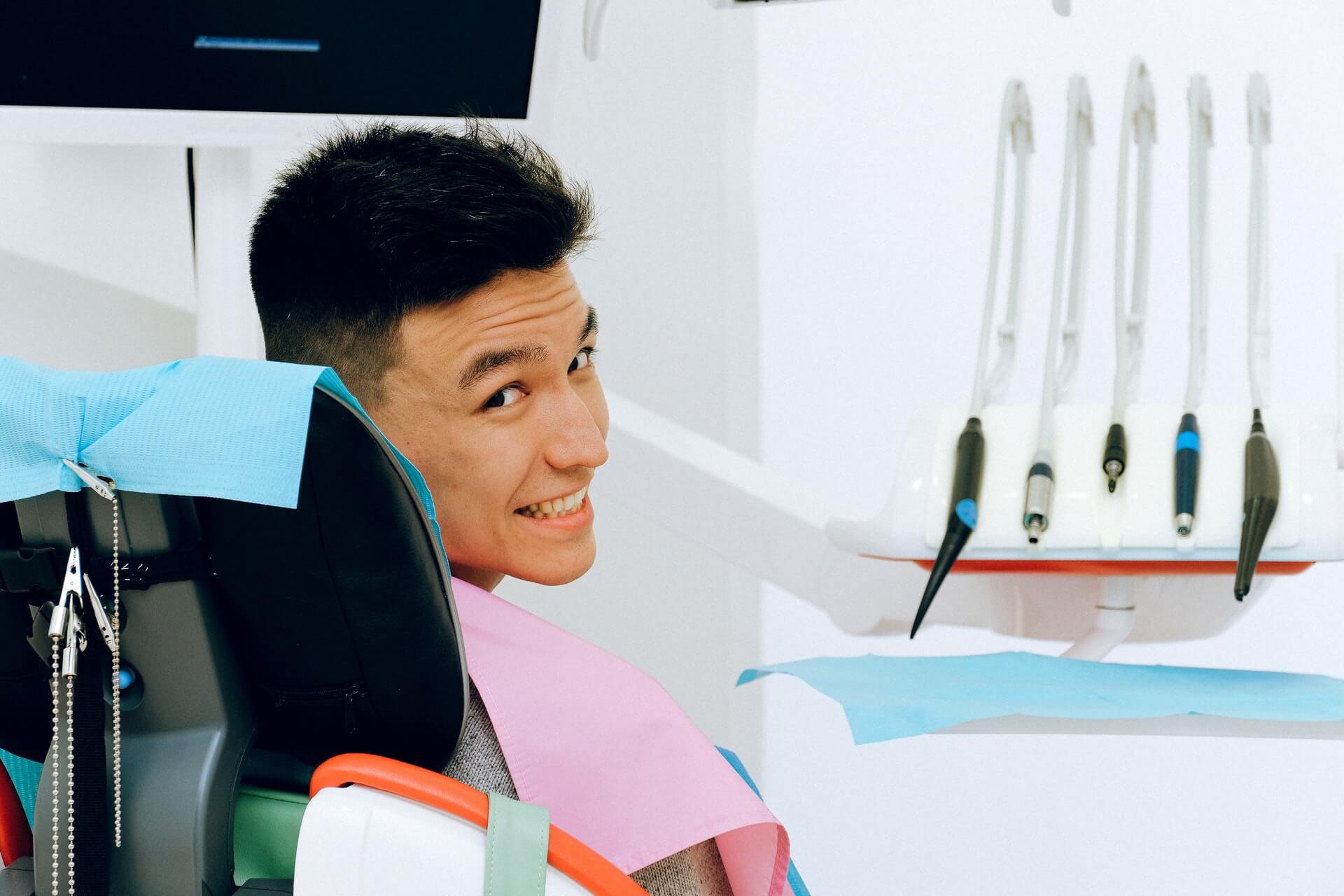 Young man smiling in a dental chair at an orthodontist office Woodland Hills.