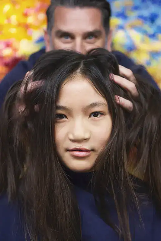 Woman getting her hair styled by a professional hairstylist at Keplerfilm.