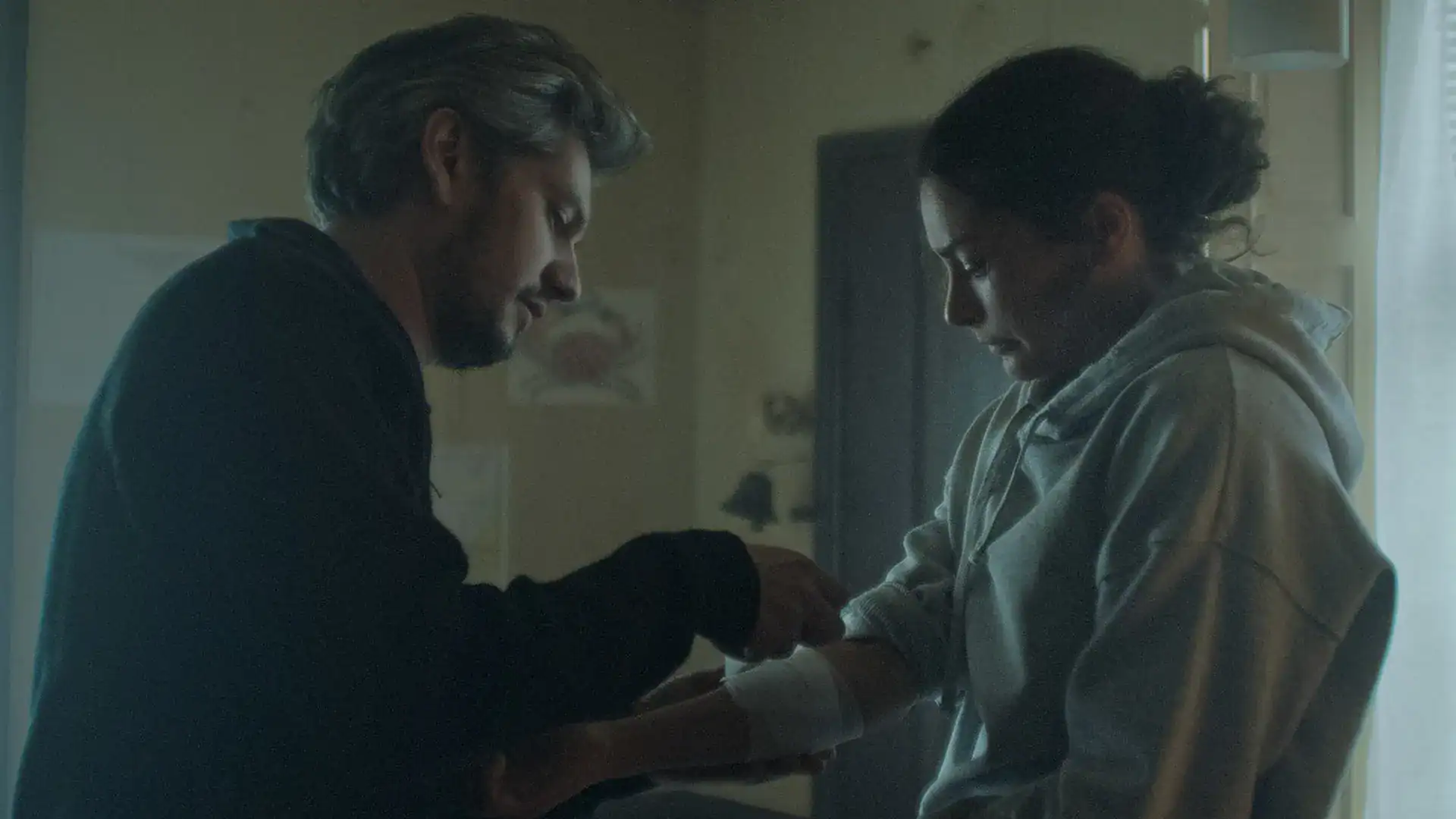 Intimate scene showing a man and woman sharing a heartfelt moment in a film production.