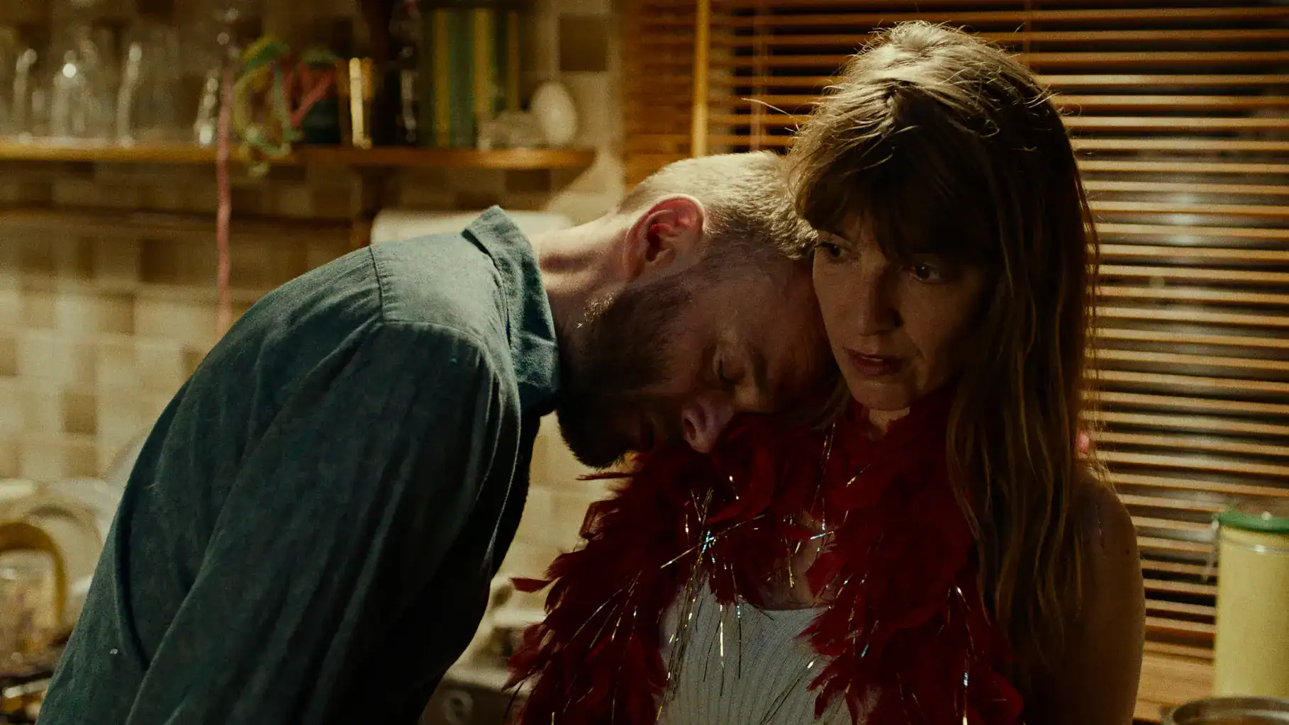 Intimate scene from a Keplerfilm production featuring a man and woman in a cozy, warmly lit setting.
