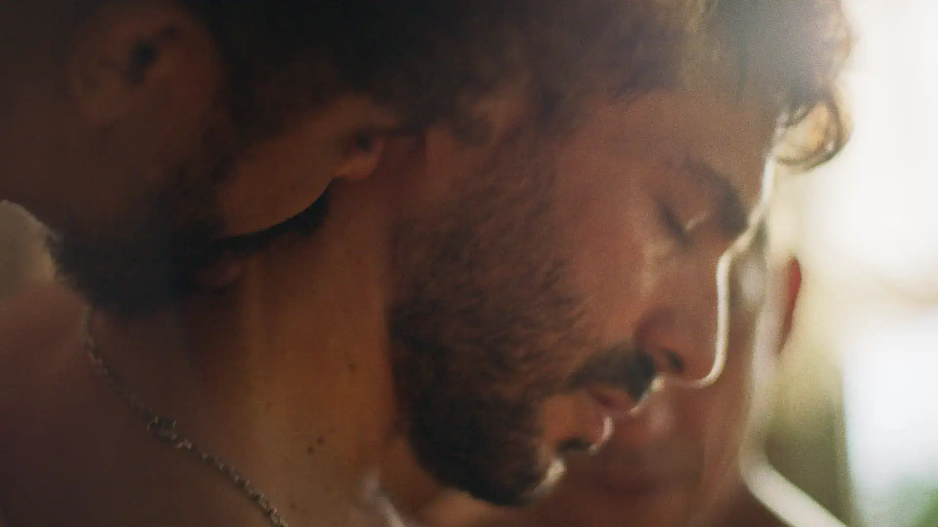 Close-up of a man with a beard and closed eyes, capturing a moment of focus.