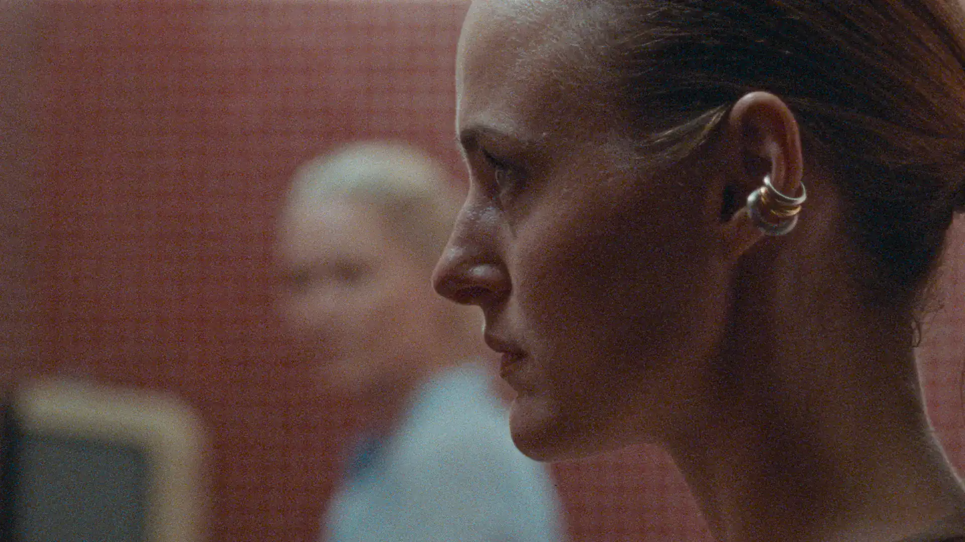 Close-up of a woman with a focused expression, emphasizing storytelling and cinematic quality.