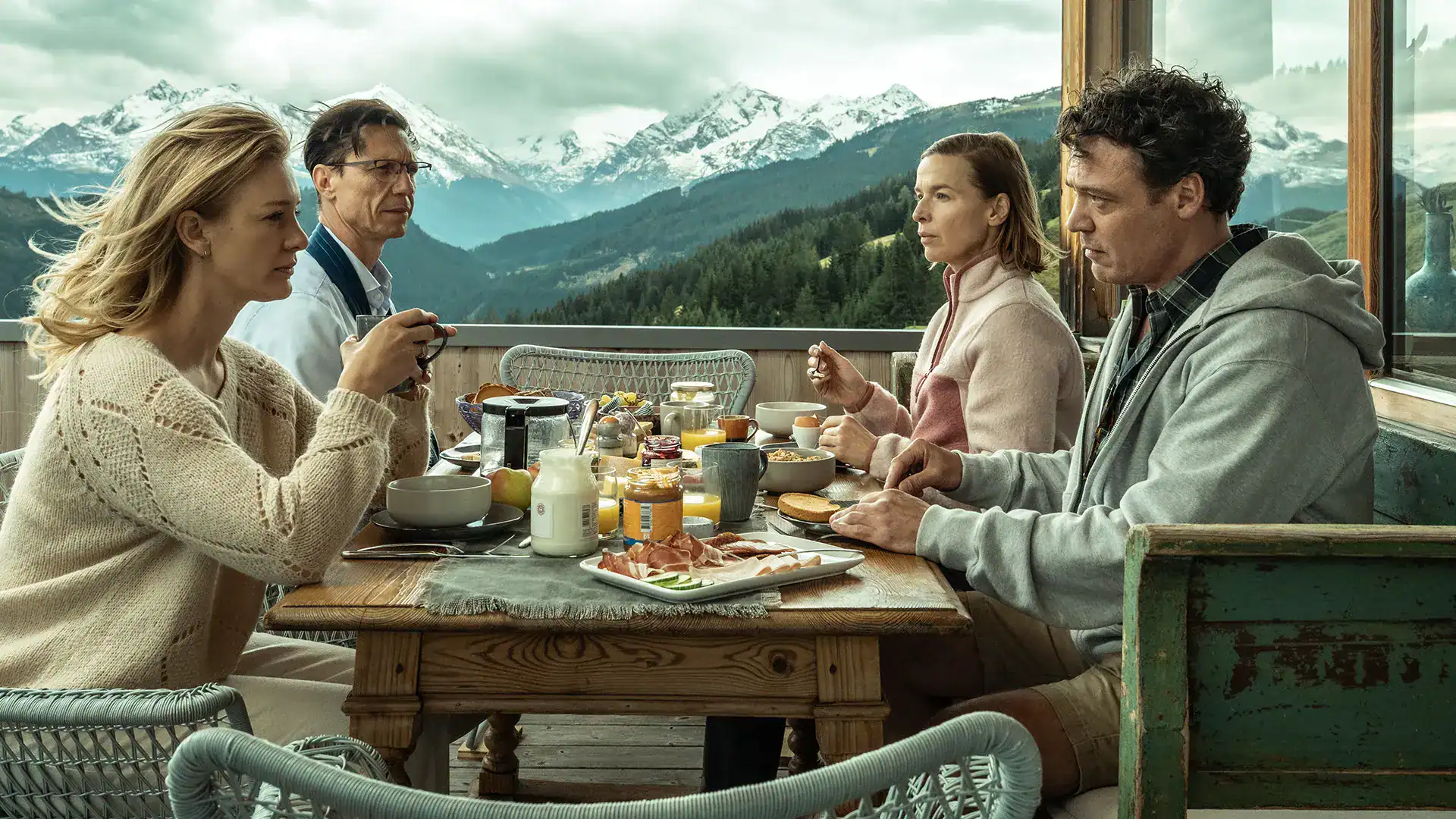 Family enjoying breakfast with mountain view at Keplerfilm production.