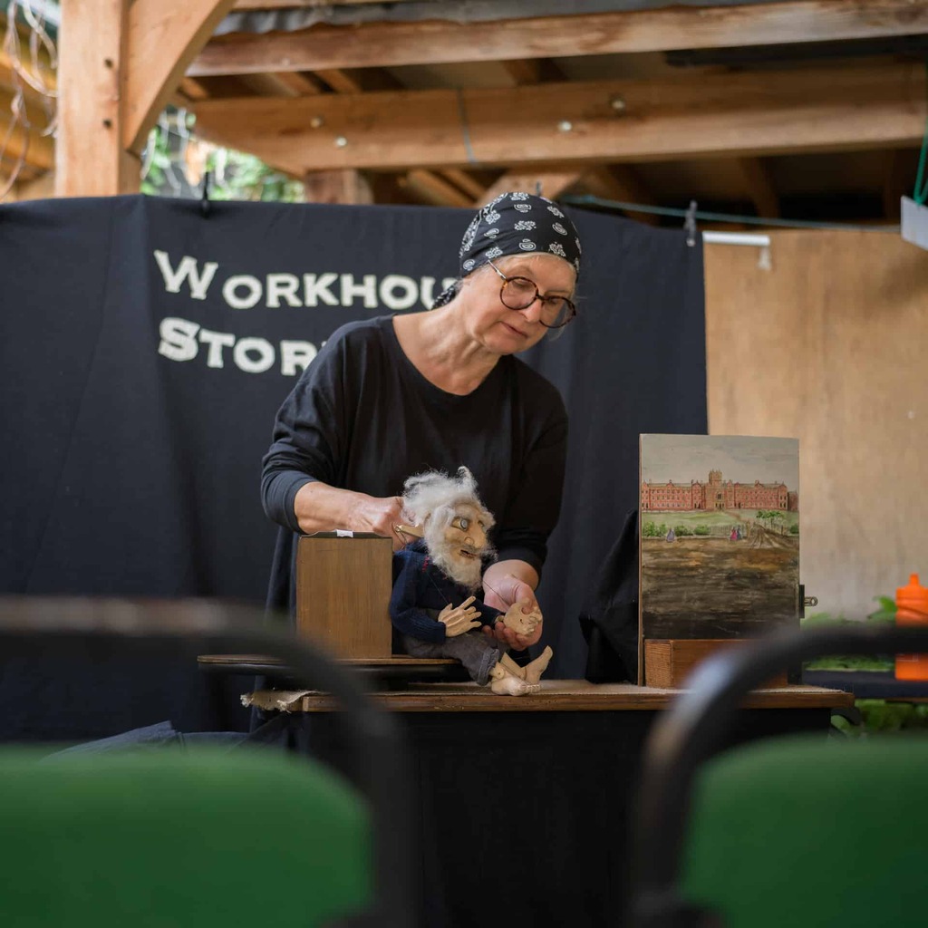 An artist performing puppetry.