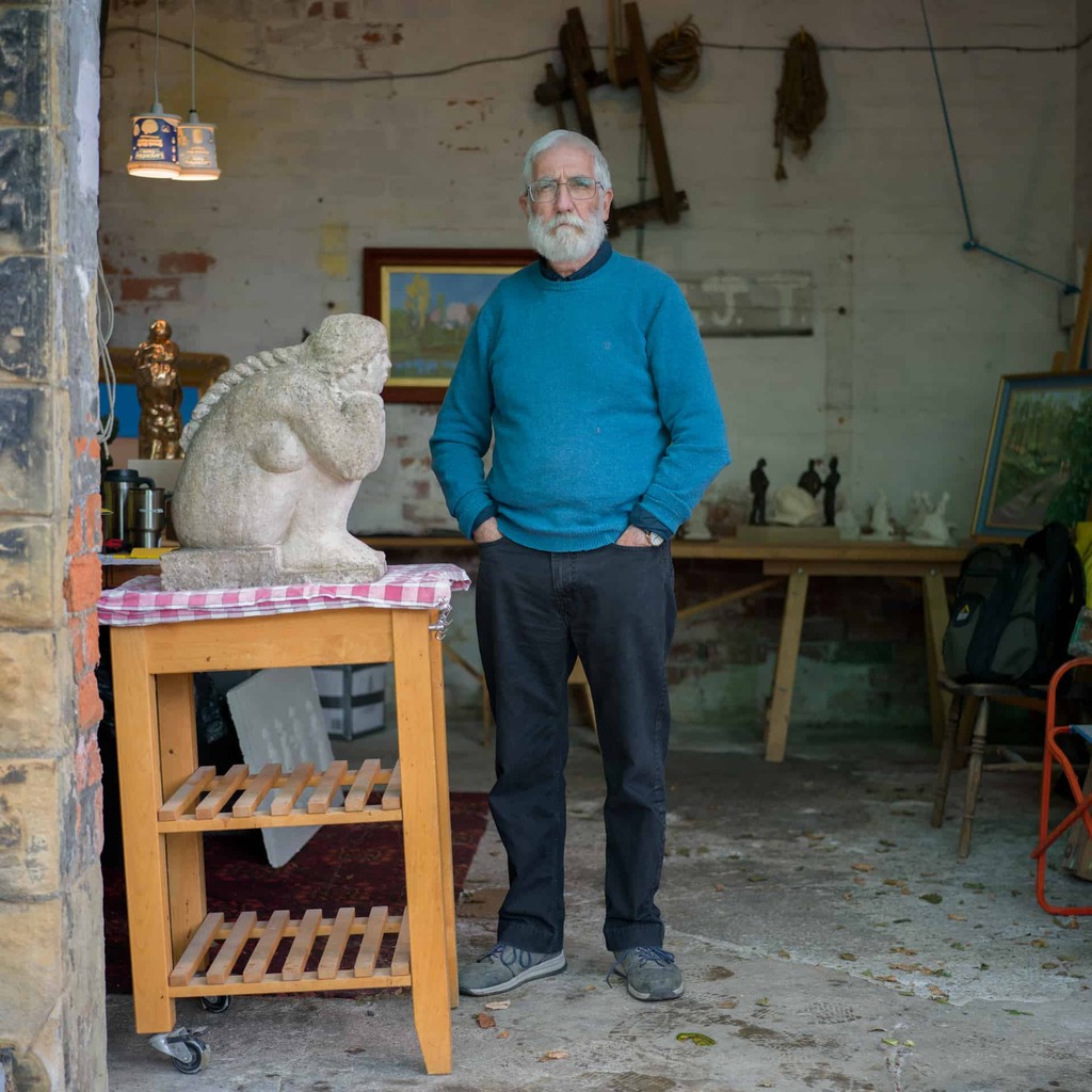 Artist Ian Judd in his workshop with his sculptures.