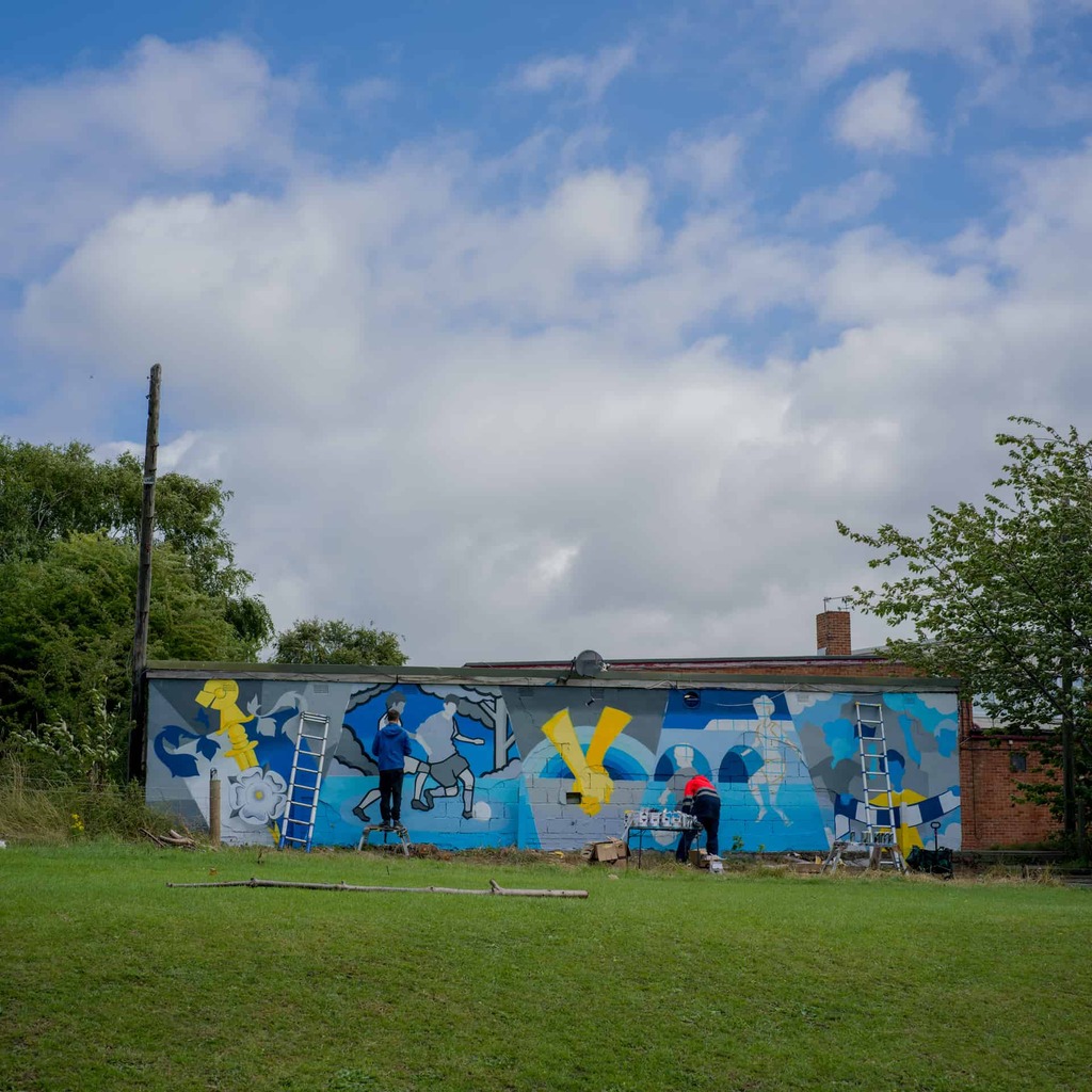 A playing field wall painted with a mural
