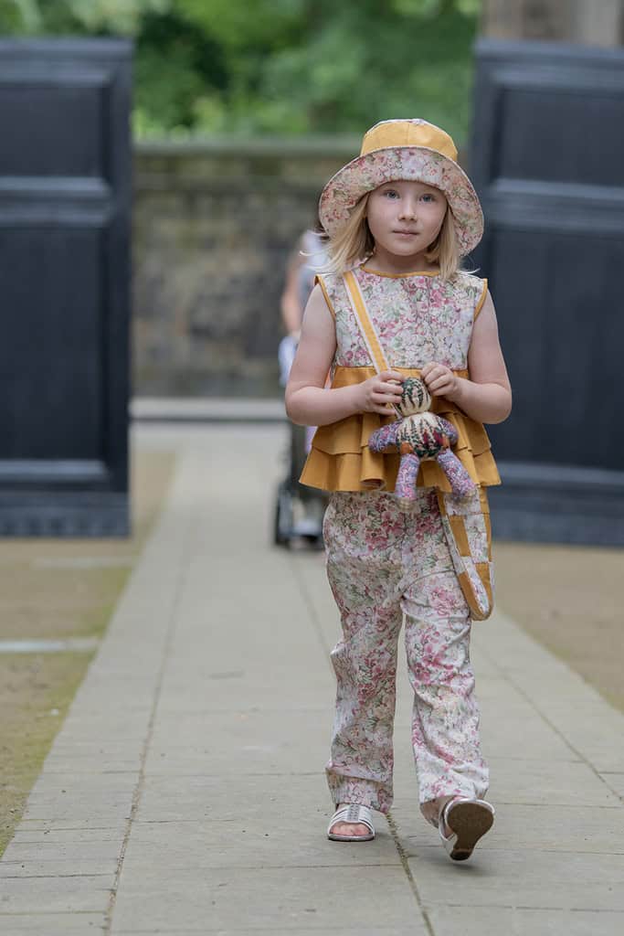 A young girl models matching trousers and top