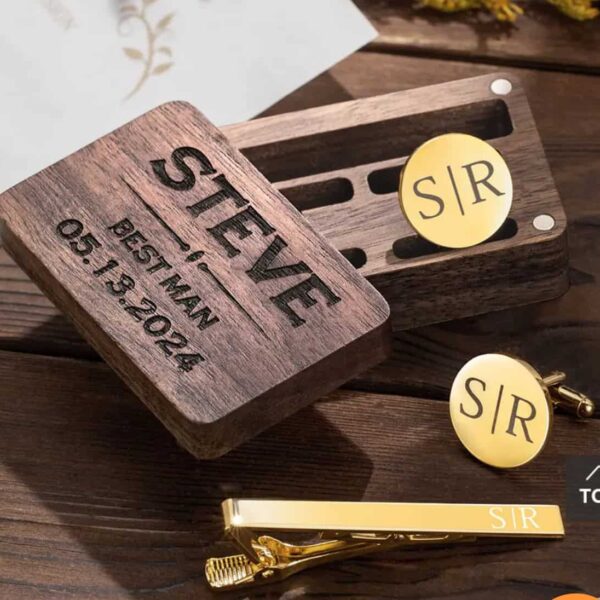 A wooden box engraved with STEVE, BEST MAN, 05.13.2024 sits beside the Personalised Cufflinks and Tie Clip Gift Set, both engraved with S|R, on a wooden surface—an elegant personalised gift for special occasions.