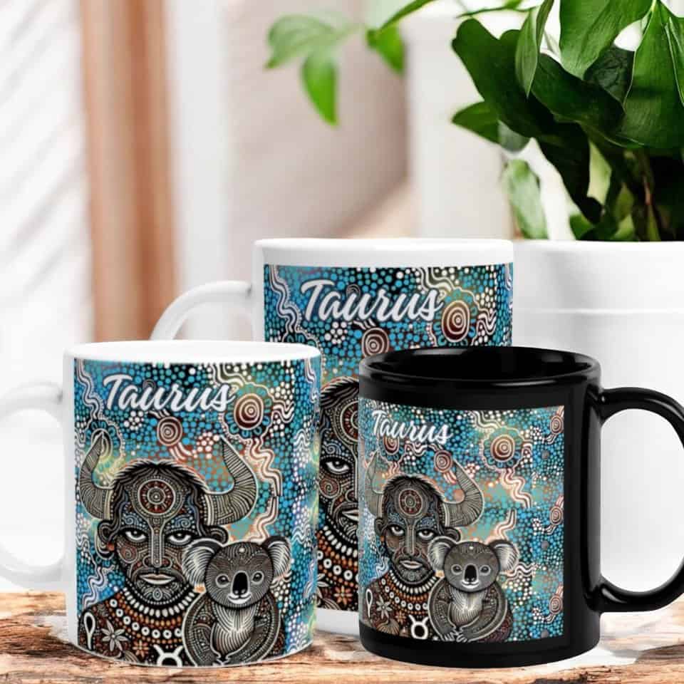 Three Taurus Horned Man with Koala Aboriginal Art Mugs, each featuring a bull and koala design in koala Aboriginal art style with Taurus written above, displayed on a wooden surface next to a green potted plant.