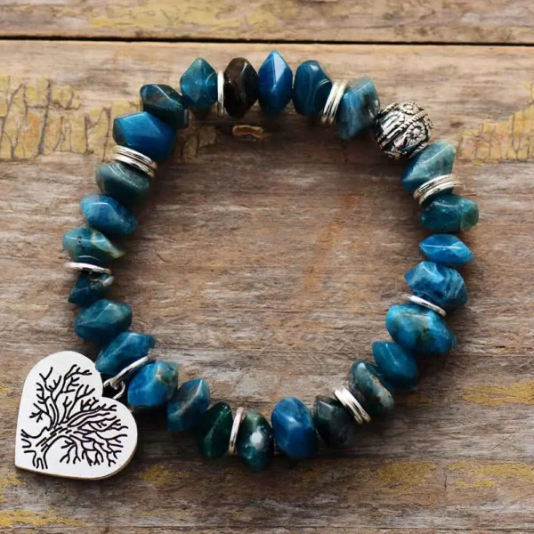 blue apatite stone bracelet with siver heart shaped charm featuring iimage of the tree of life