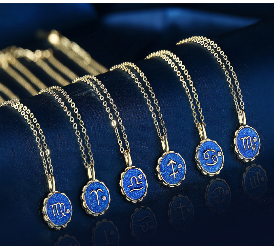 Six Copper Micro-inlaid Zodiac Couple Necklaces with blue circular pendants, each showing a unique zodiac sign, are neatly arranged on a dark blue velvet background.