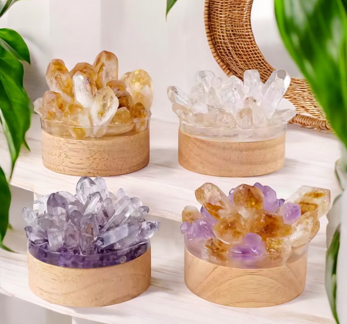Four round wooden containers hold Natural Stone Point Mood Lamps in yellow, clear, purple, and amber hues. Theyre displayed on white shelves with green plants and a wicker-framed mirror in the background.