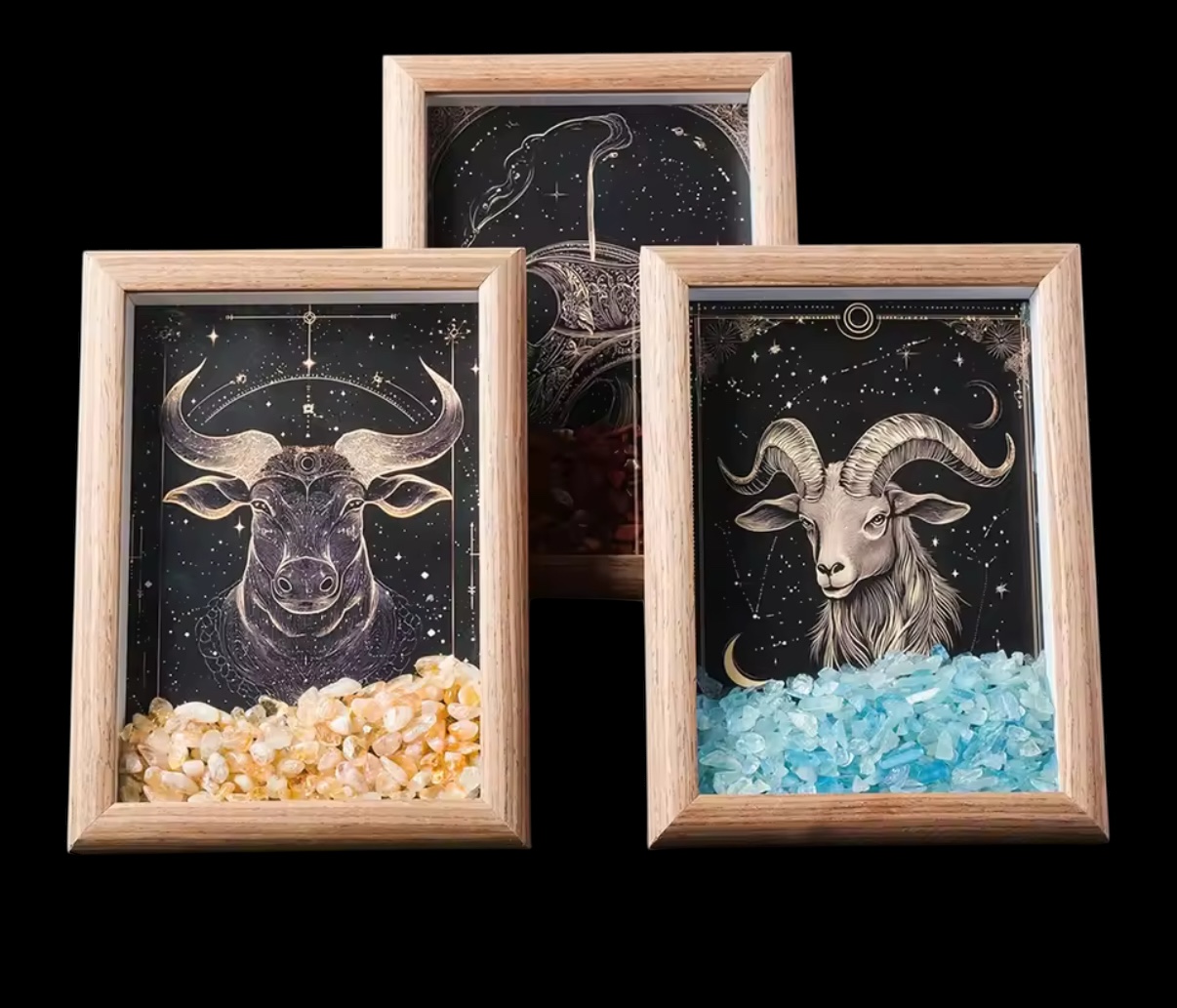 The Zodiac Crystal Frame – Astrology Wall Art with Healing Crystals features Taurus (yellow crystals), Capricorn (blue stones), and Cancer (red stones) on a black starry background, each showcasing its astrological constellation.