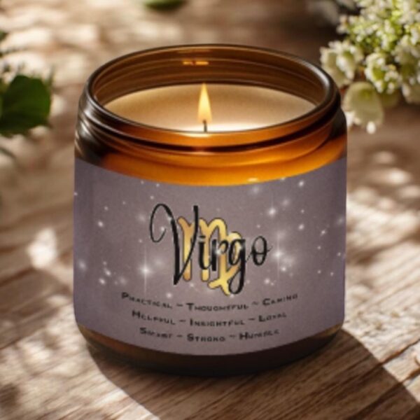 A lit brown glass candle sits on a wooden surface. The label reads Virgo with descriptive words below, including practical, thoughtful, caring, helpful, insightful, loyal, smart, strong, and humble. Flowers are in the background.