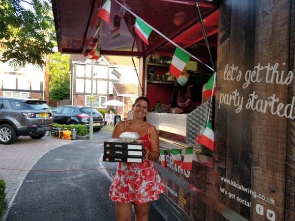 Wedding guest collecting a fresh pizza from a KK Catering pizza van.