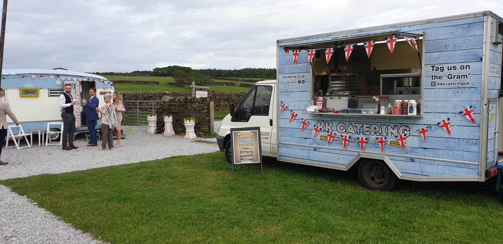 Freshly prepared street food catering truck at outdoor event, serving UK celebration food and drinks.