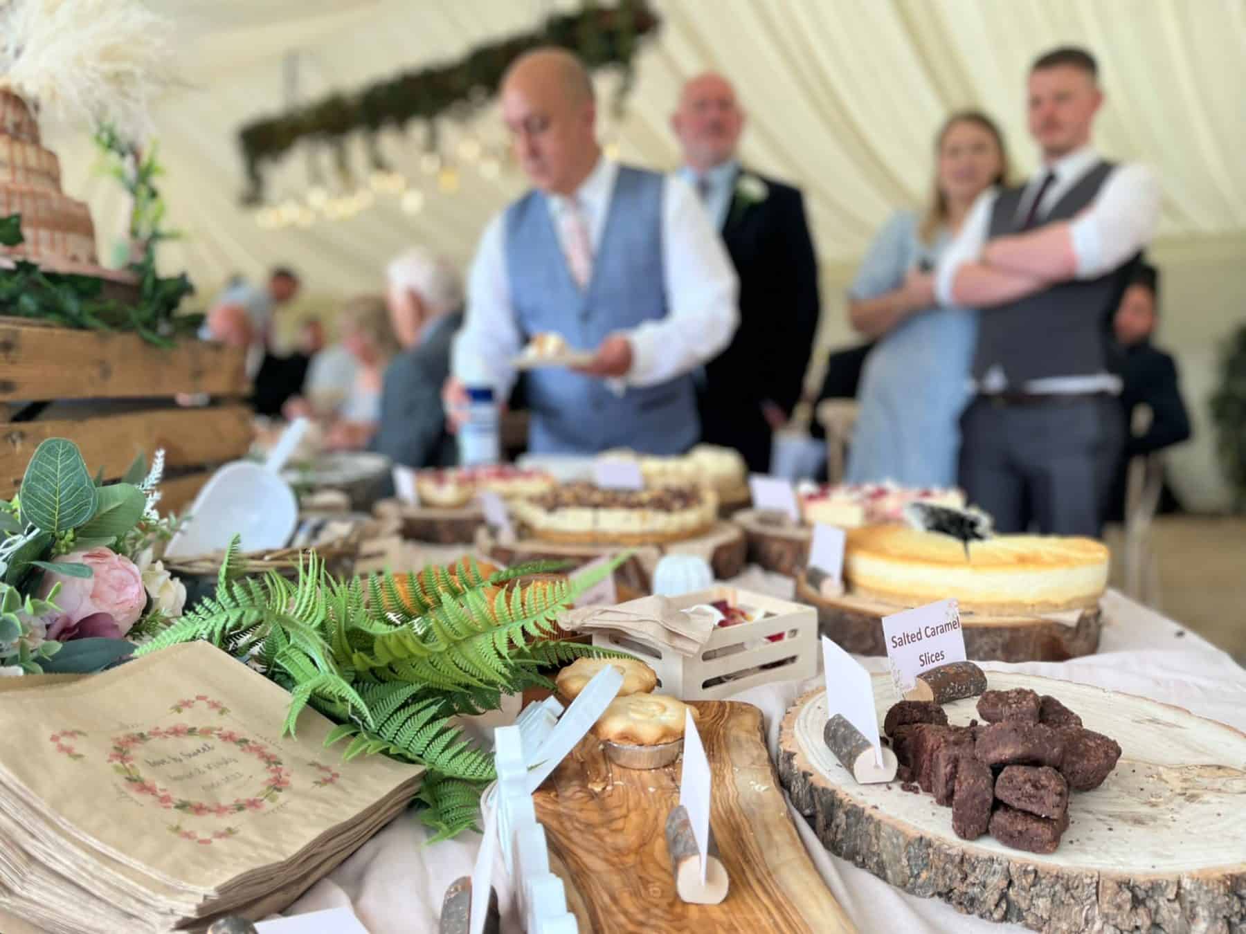 Delicious dessert table at a wedding reception with a variety of cakes, brownies, and sweet treats.