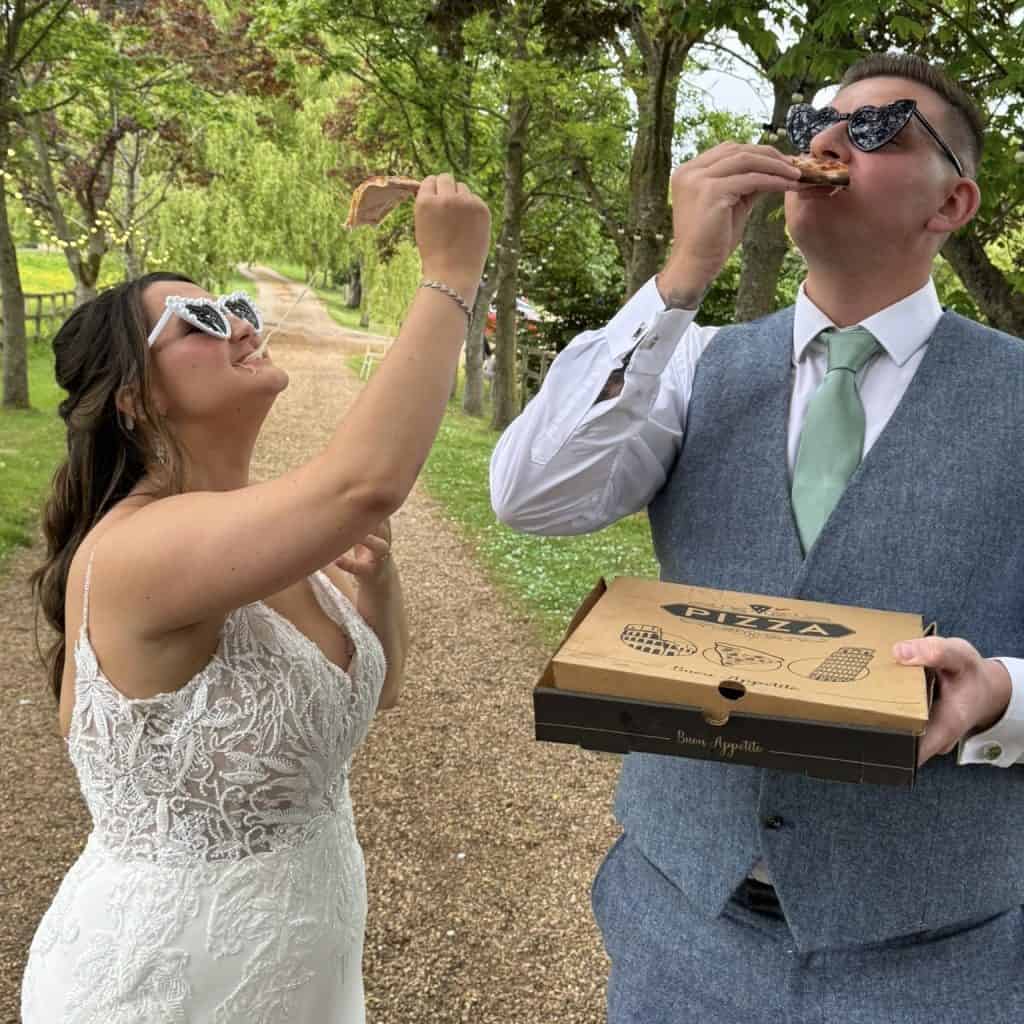 bride and groom tucking into their pizzas at everdon hall