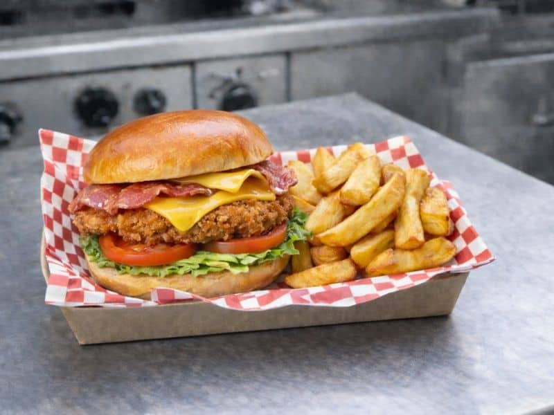 Crispy chicken and bacon sandwich with chips from KK Catering burger van.