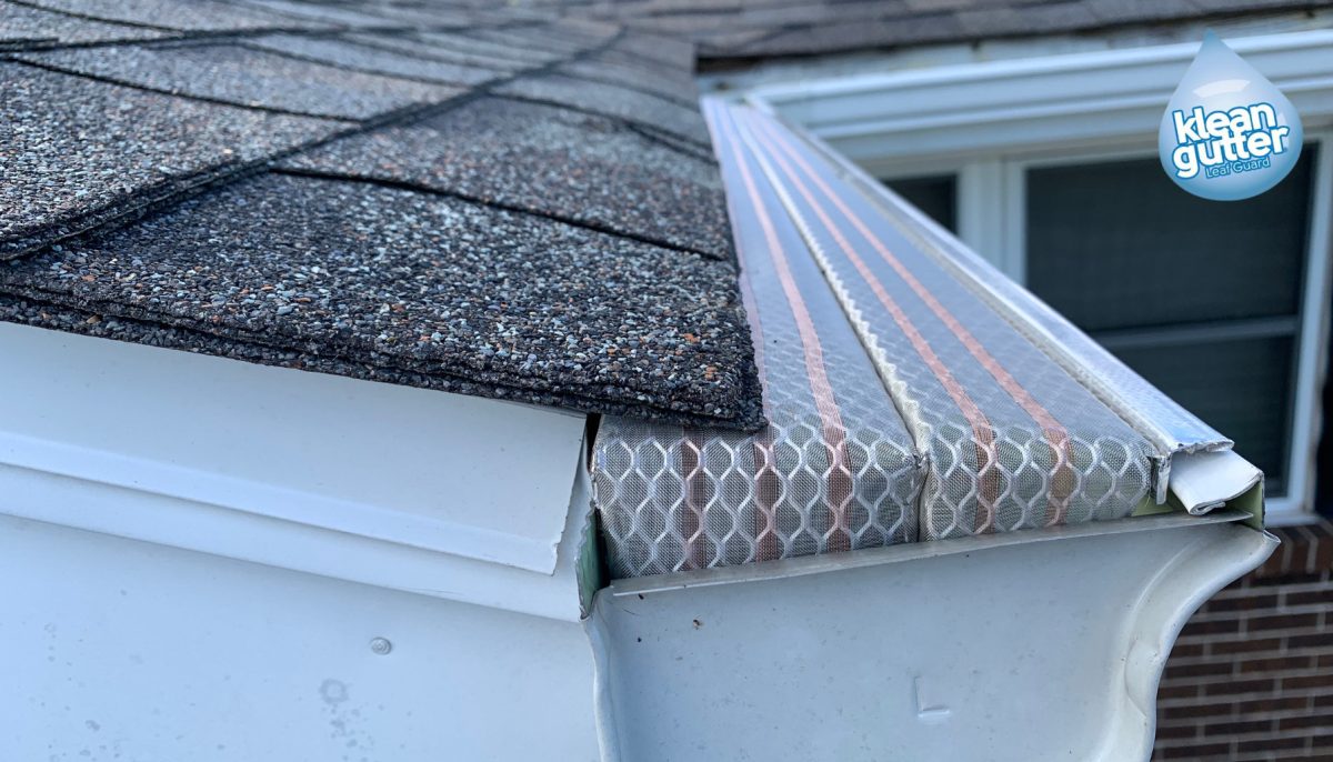 Klean Gutter installed at roof pitch in the rain, water moving across a clear mesh surface.