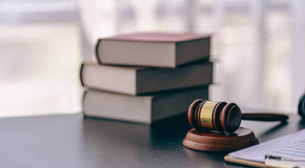 Ethical Considerations in Family Law Lawyer or judge's hammer in court The auction hammer is on the woo table. Legal subject or auction company with book sign in office